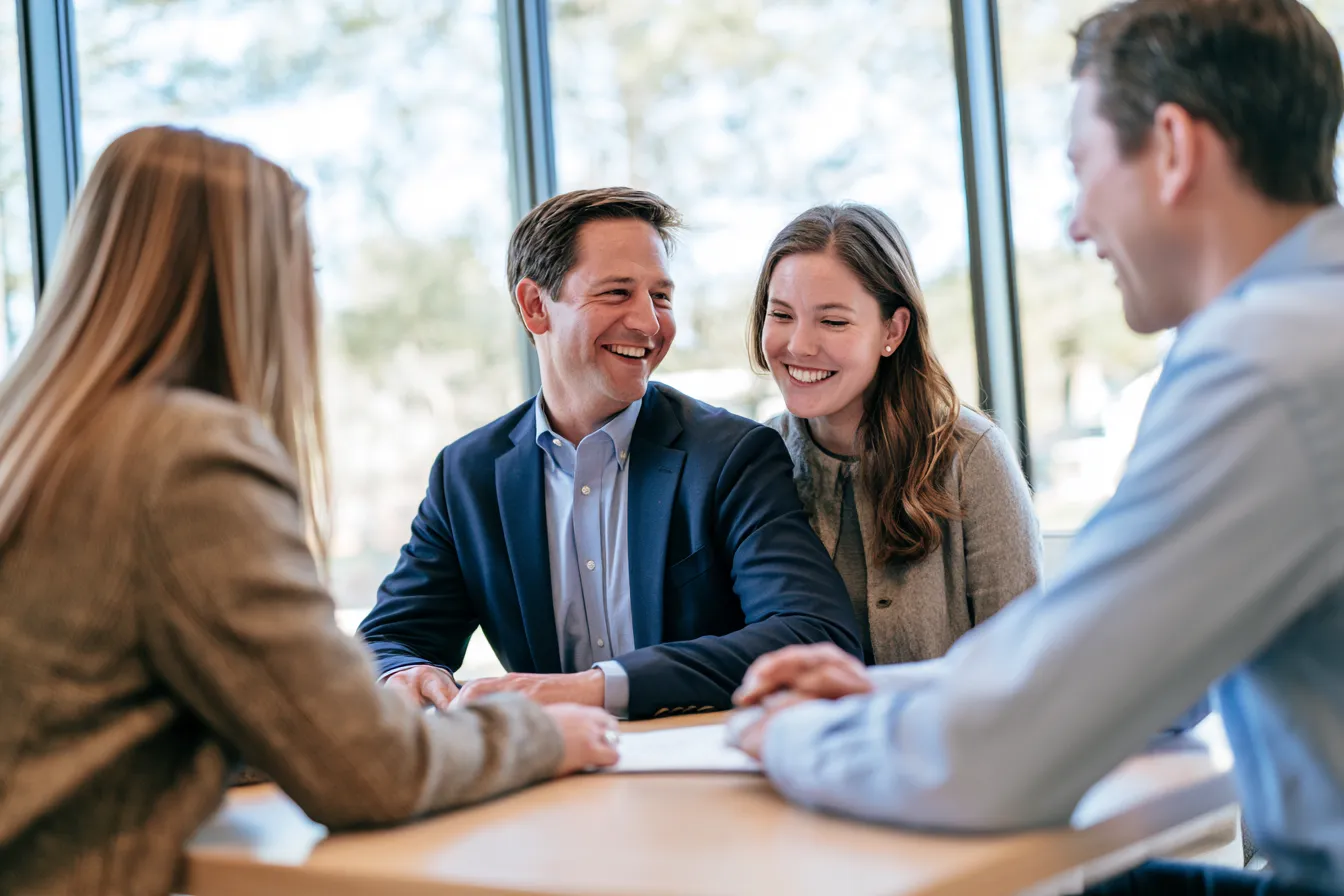 Couple reviewing personal loan paperwork with a consultant
